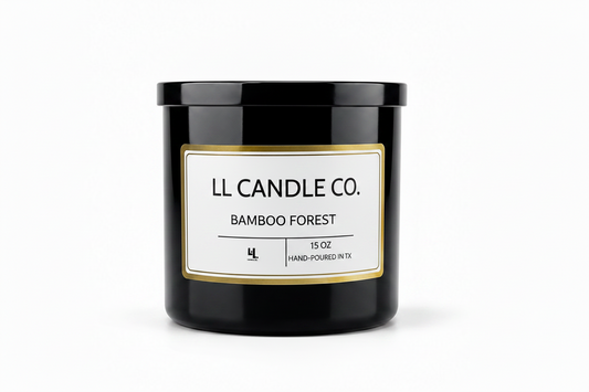 A black glass jar candle with a white label and gold border, reading 'LL CANDLE CO. BAMBOO FOREST' on a clean white background.