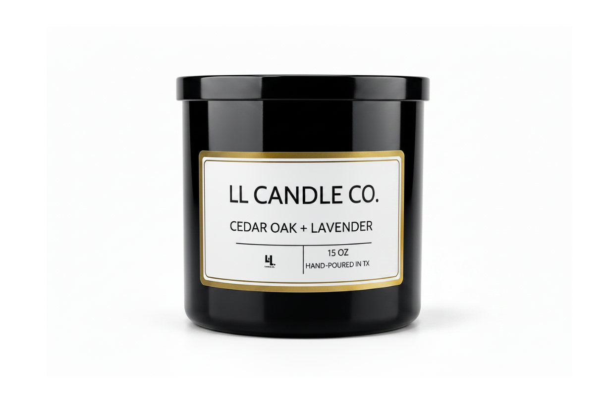 A black glass jar candle with a white label and gold border, labeled 'LL CANDLE CO. CEDAR OAK + LAVENDER' on a clean white background.