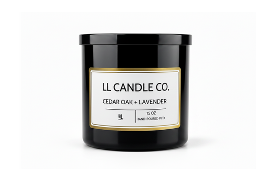 A black glass jar candle with a white label and gold border, labeled 'LL CANDLE CO. CEDAR OAK + LAVENDER' on a clean white background.