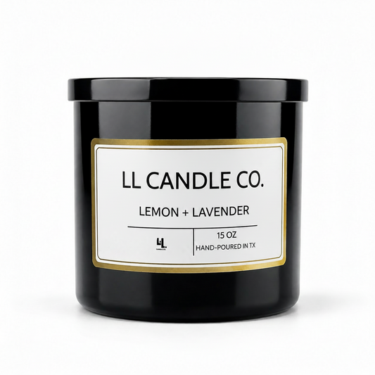 A black glass jar candle with a white label and gold border, labeled 'LL CANDLE CO. LEMON + LAVENDER' on a clean white background.