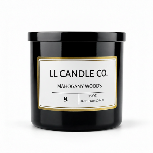 A black glass jar candle with a white label featuring gold borders and black text that reads 'LL CANDLE CO. MAHOGANY WOODS' on a clean white background.