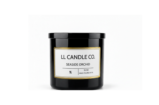 A black glass jar candle with a black lid and a white label featuring a gold border. The label reads 'LL CANDLE CO.