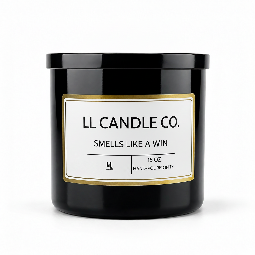 A black glass jar candle with a white label and gold border, reading 'LL CANDLE CO. SMELLS LIKE A WIN' on a clean white background.